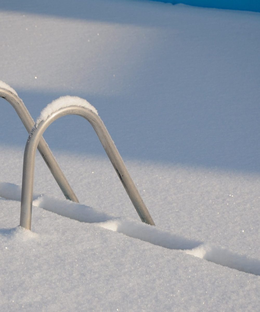 Snowy swimming pool stairs in the winter